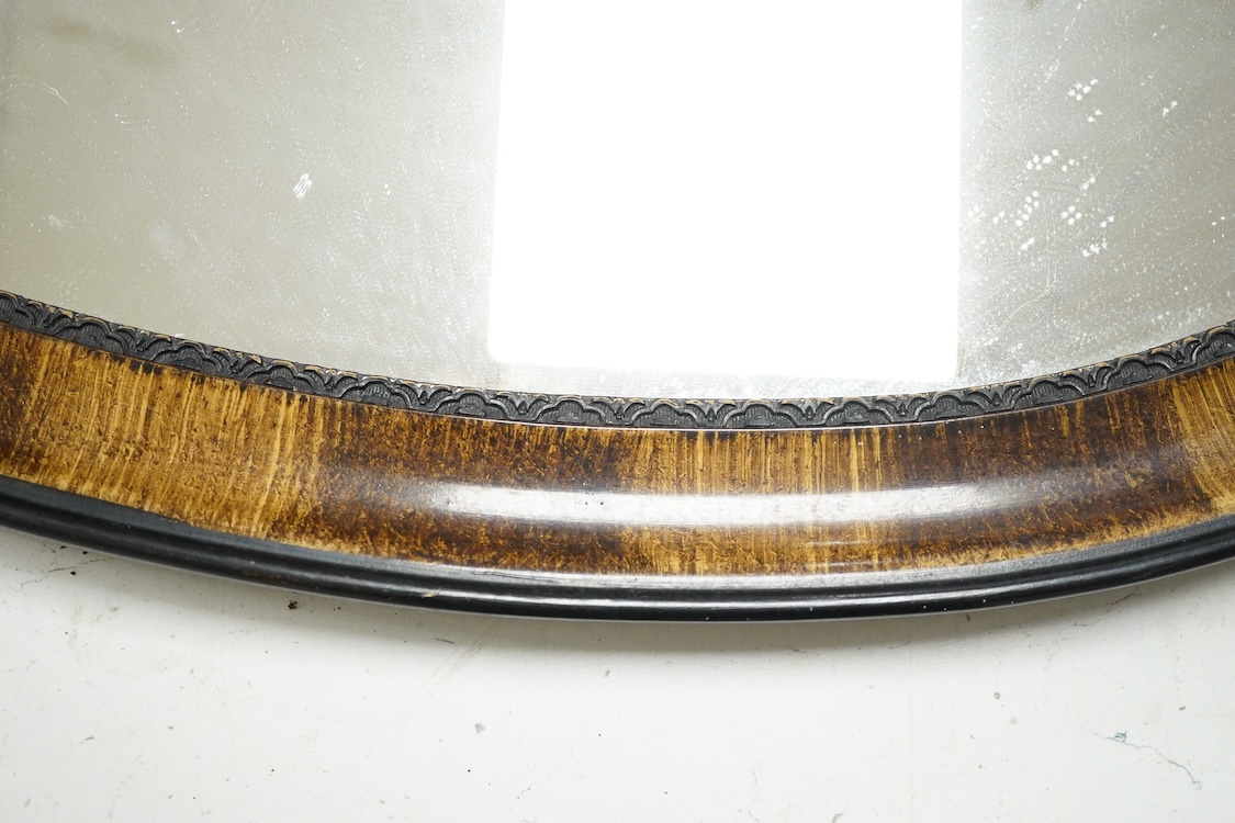 A mahogany toilet mirror and an oval wall mirror, 77cm wide